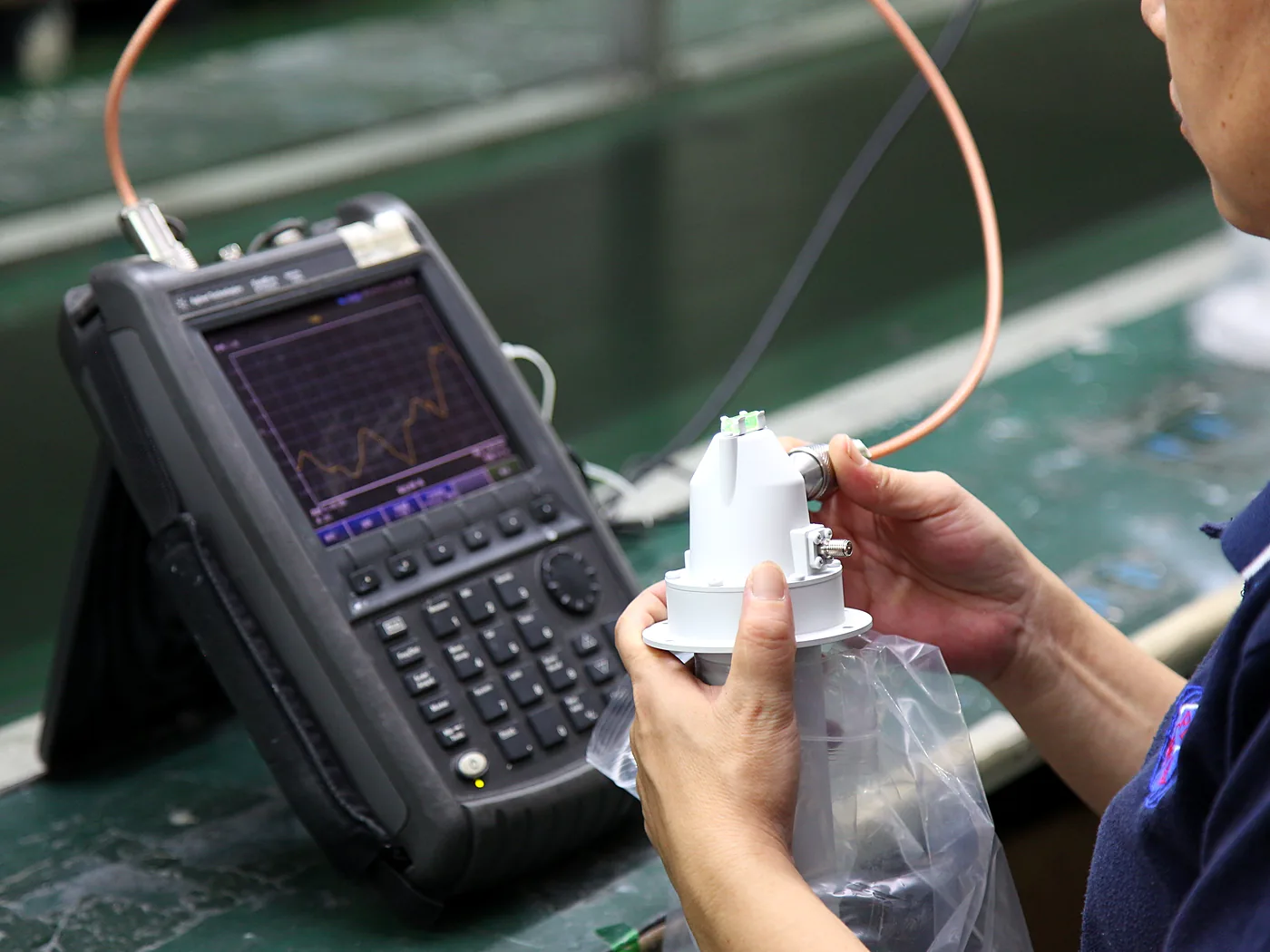 Technician checking a machined part with digital calipers