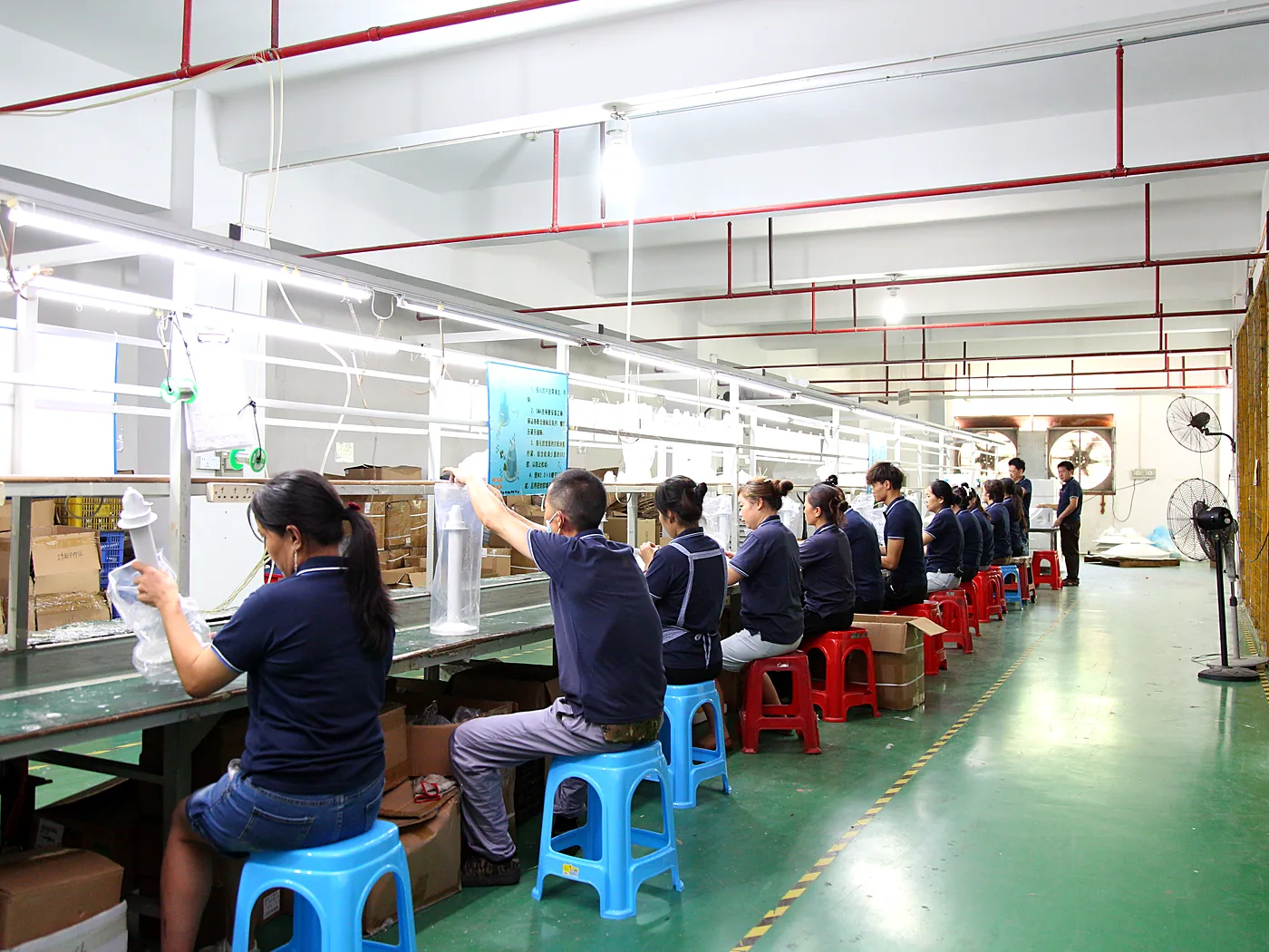 Operators assembling components at a bench