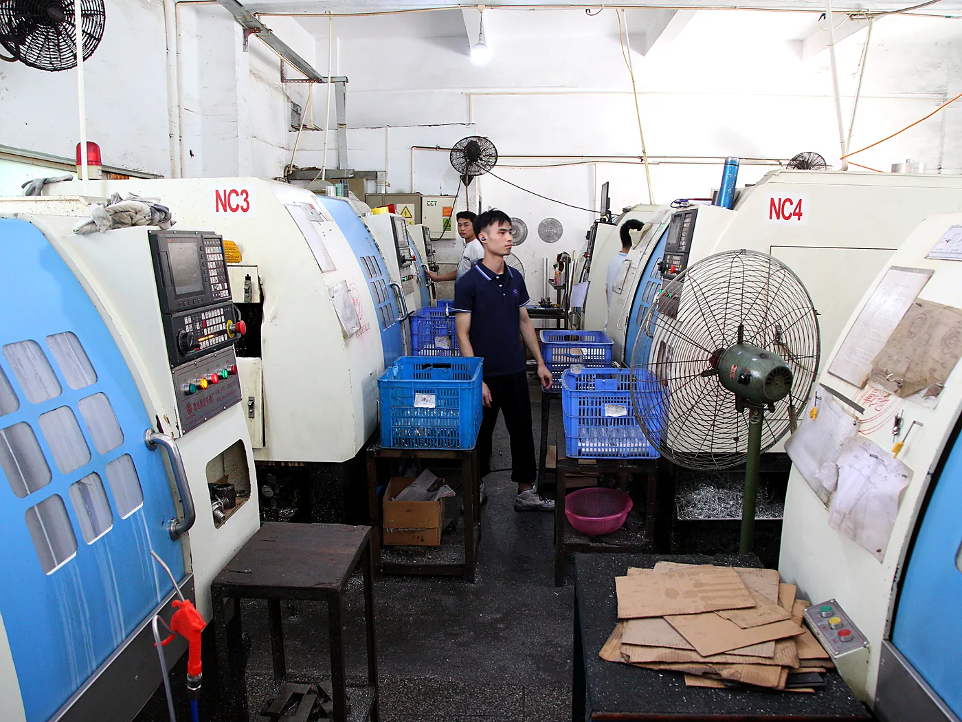 Row of CNC lathes in the machining bay