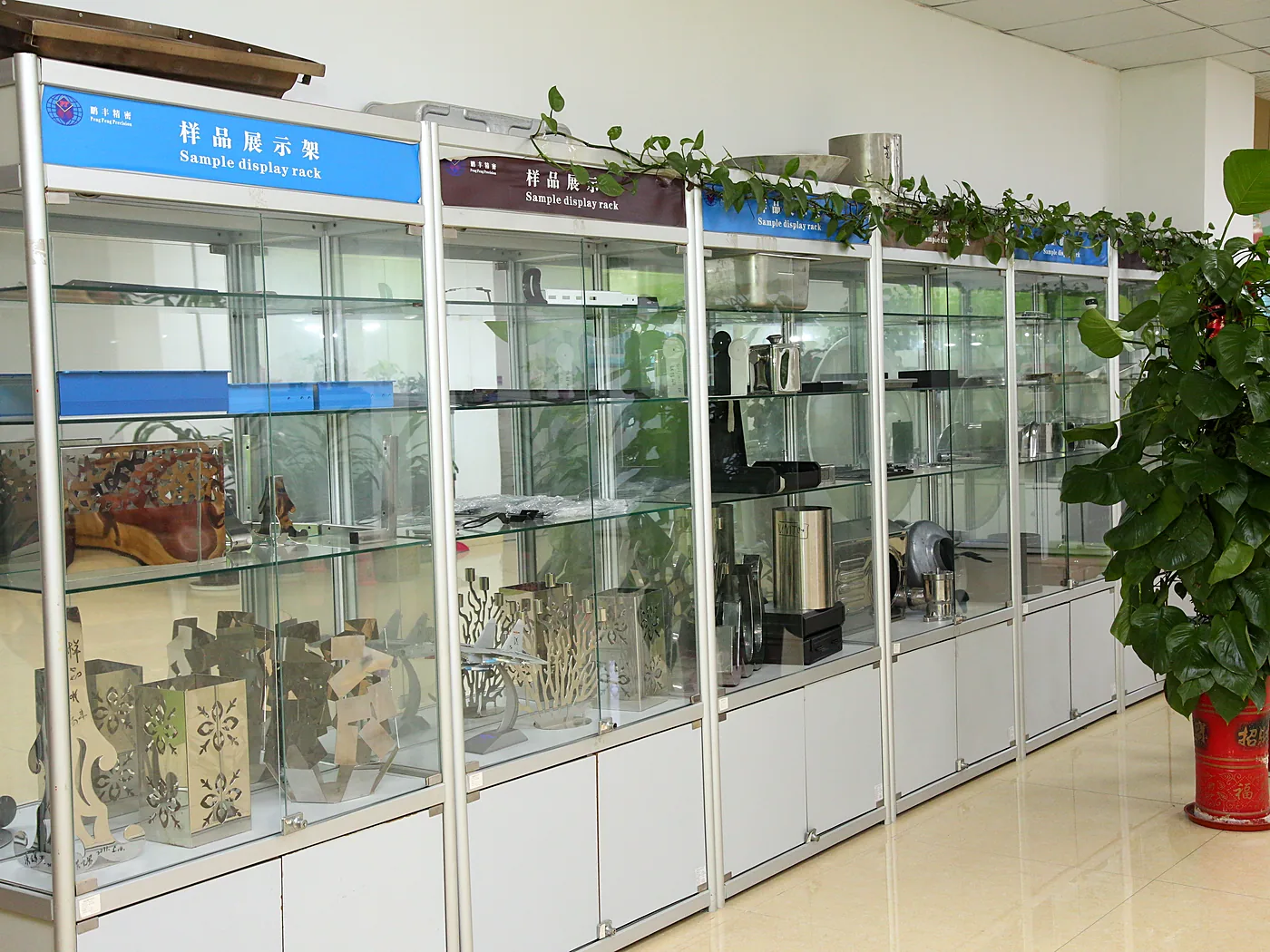 Glass display cabinets of finished sample parts along a corridor
