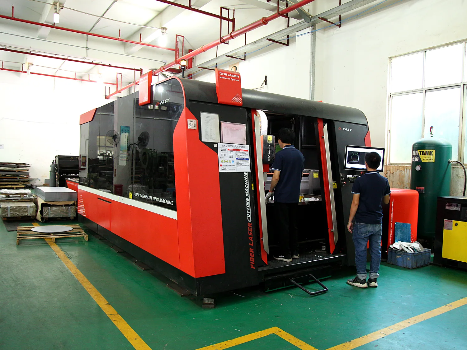 Red automated machining centre with safety light curtain