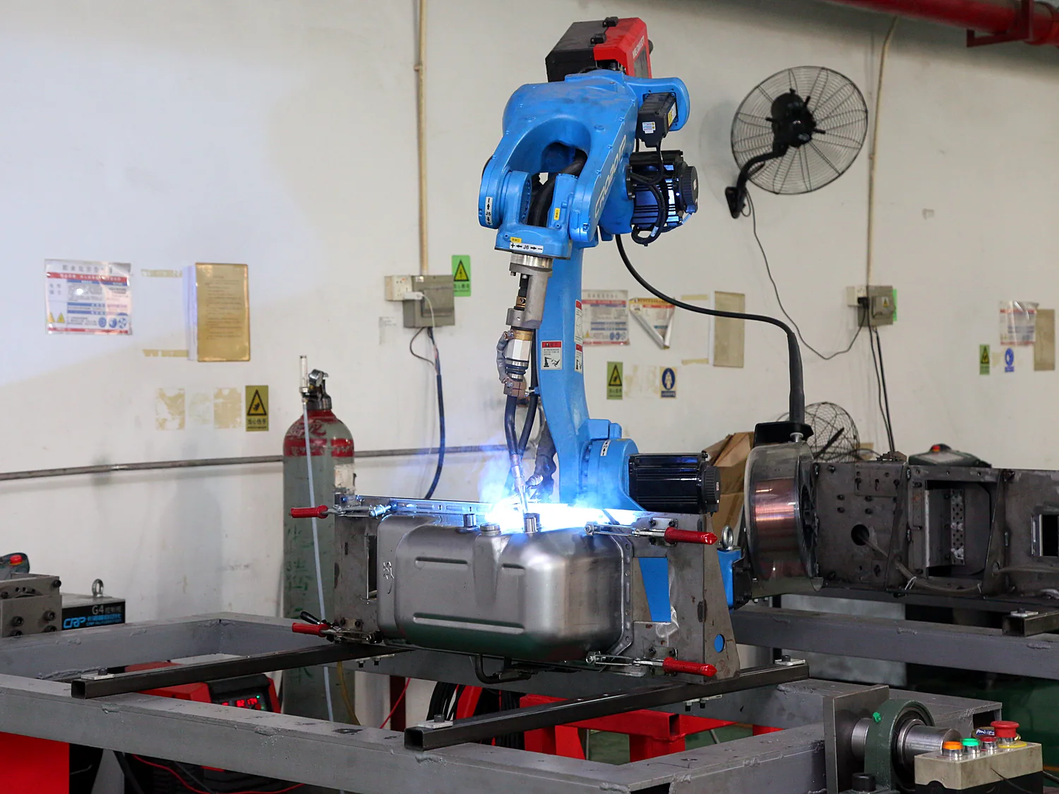 Robotic arm positioned over a clamped workpiece