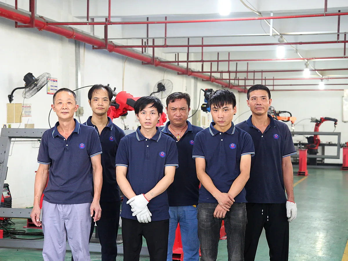Ten-person team photographed on the shop floor