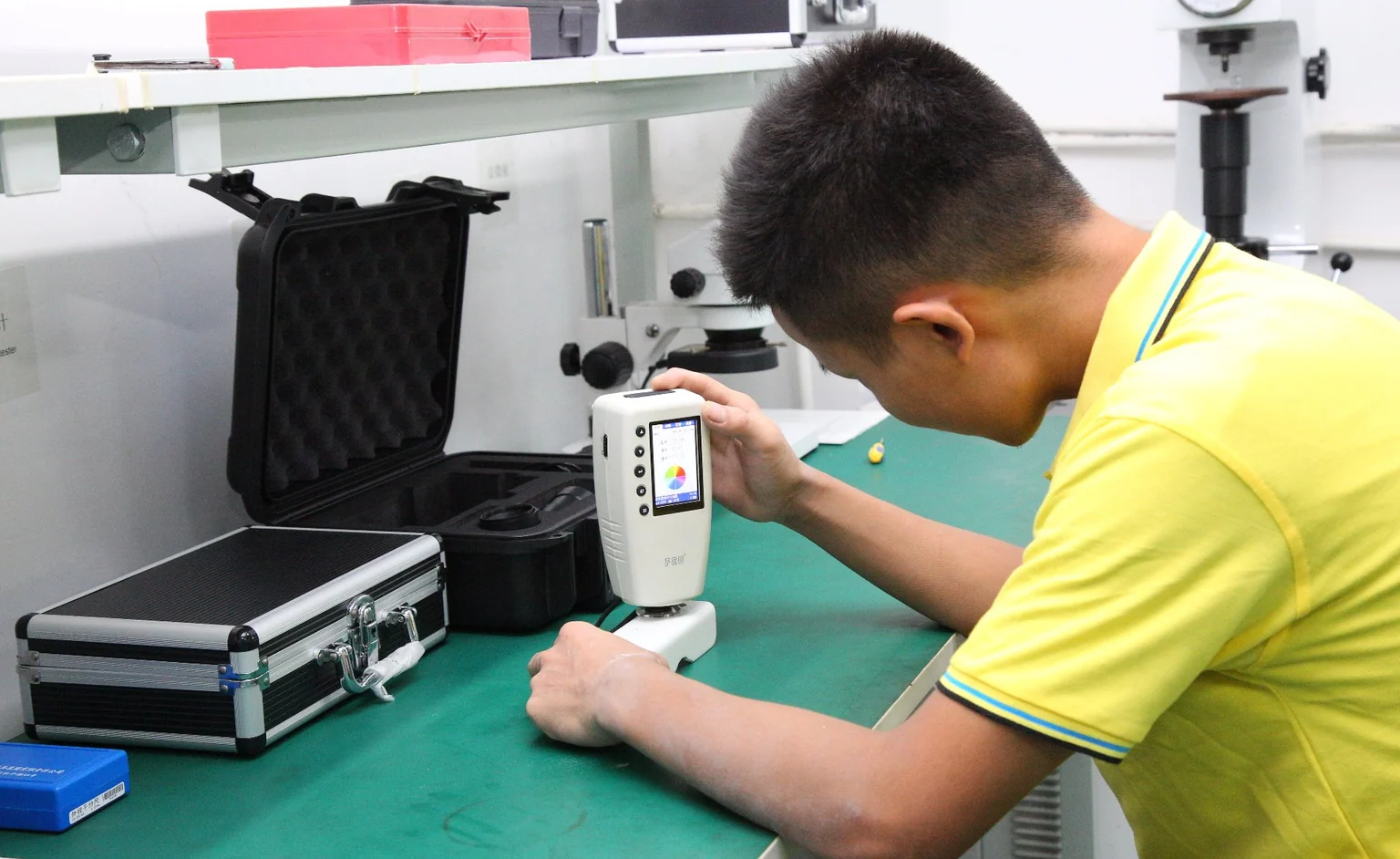 Inspector checking a machined part with a handheld measuring instrument